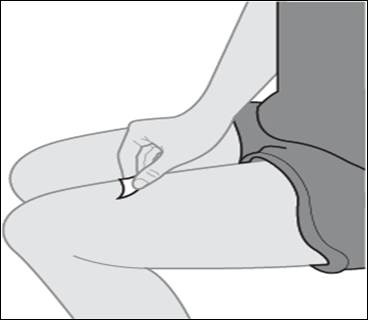 A person sitting down holding something on their leg
Description automatically generated